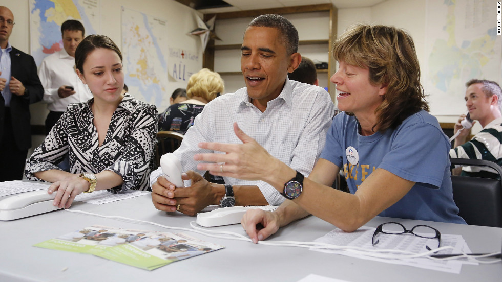 Obama jokes about a telephone with campaign volunteers Alexa Kissinger, left, and Suzanne Stern as he makes calls from a campaign office in Williamsburg, Virginia, on Sunday, October 14.