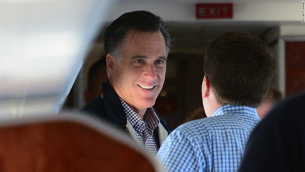 Republican presidential candidate Mitt Romney talks with aides aboard his campaign plane en route to Ronkonkoma, New York, on Tuesday.