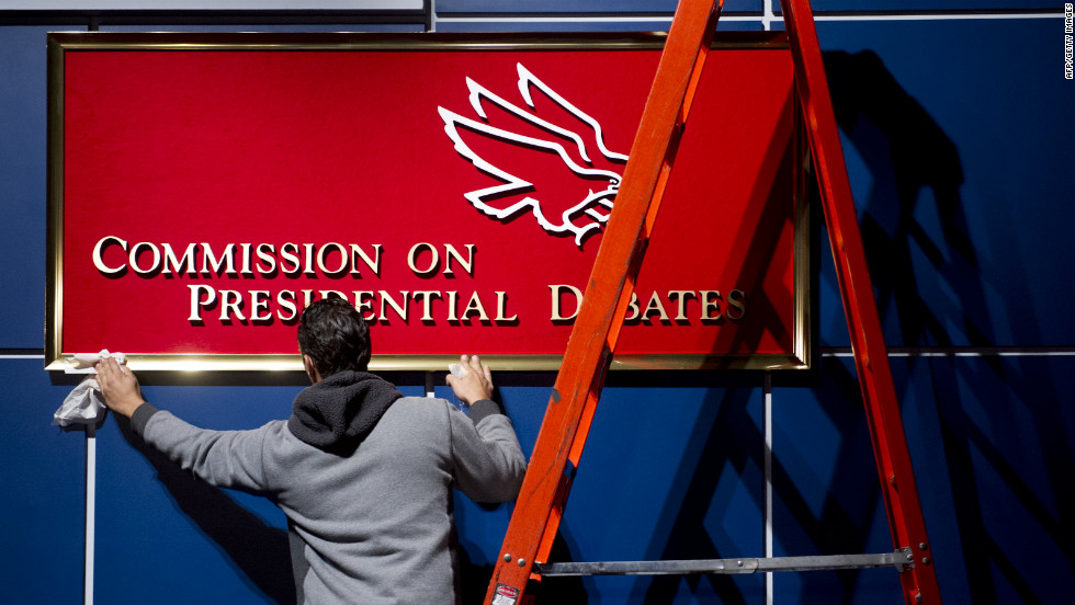 A worker cleans a sign for the Commission on Presidential Debates before the second presidential debate in Hempstead, New York, on Tuesday.