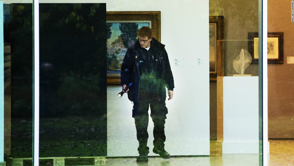 A investigator searches the Rotterdam Kunsthal museum following the break-in. The stolen works belong to a private collection that was being shown to the public for the first time.