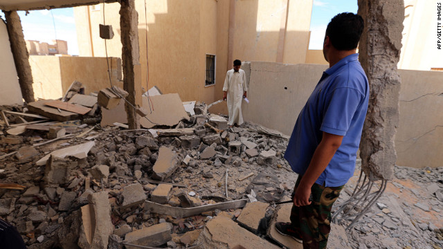 Libyan men inspect a destroyed building in Bani Walid, about 115 miles southeast of Tripoli, last week. 