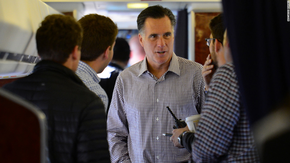 Romney speaks with campaign staff on board his campaign plane at Washington Dulles International Airport in Chantilly, Virginia, on Thursday, October 18.