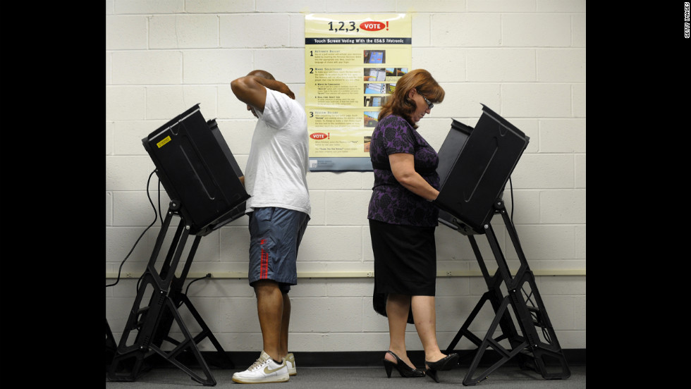 Jack Bunn, 51, and Jane Cookson, 57, cast their votes at the Board of Elections early voting station in Wilson, North Carolina, on Thursday.