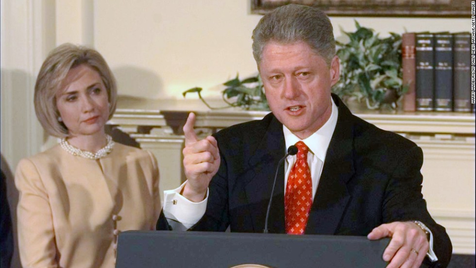 Clinton looks on as her husband discusses the Monica Lewinsky scandal in the Roosevelt Room of the White House on January 26, 1998. Clinton declared, &quot;I did not have sexual relations with that woman.&quot; In August of that year, Clinton testified before a grand jury and admitted to having &quot;inappropriate intimate contact&quot; with Lewinsky, but he said it did not constitute sexual relations because they had not had intercourse. He was impeached in December on charges of perjury and obstruction of justice.