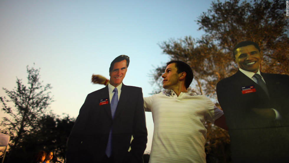 Bartek Wawruch stands between cardboard cutouts of Obama and Romney at Lynn University in Boca Raton, Florida, on Saturday, October 20, as the campus prepares for Monday&#39;s presidential debate.