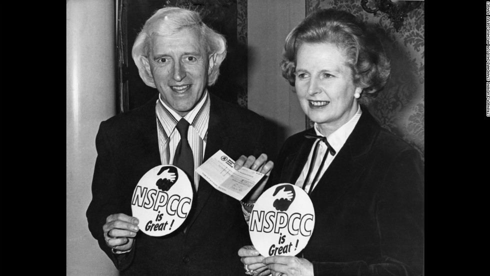 Savile poses with British Prime Minister Margaret Thatcher at a National Society for the Prevention of Cruelty to Children fund-raising presentation in 1980.