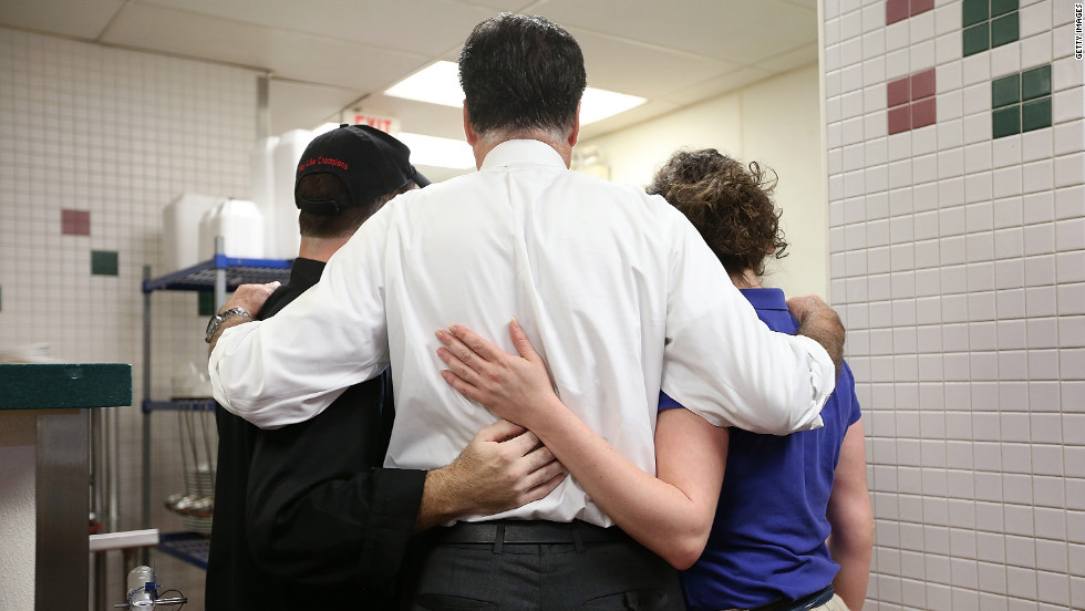 Romney, center, poses for a photo with workers at First Watch Cafe on Thursday. 