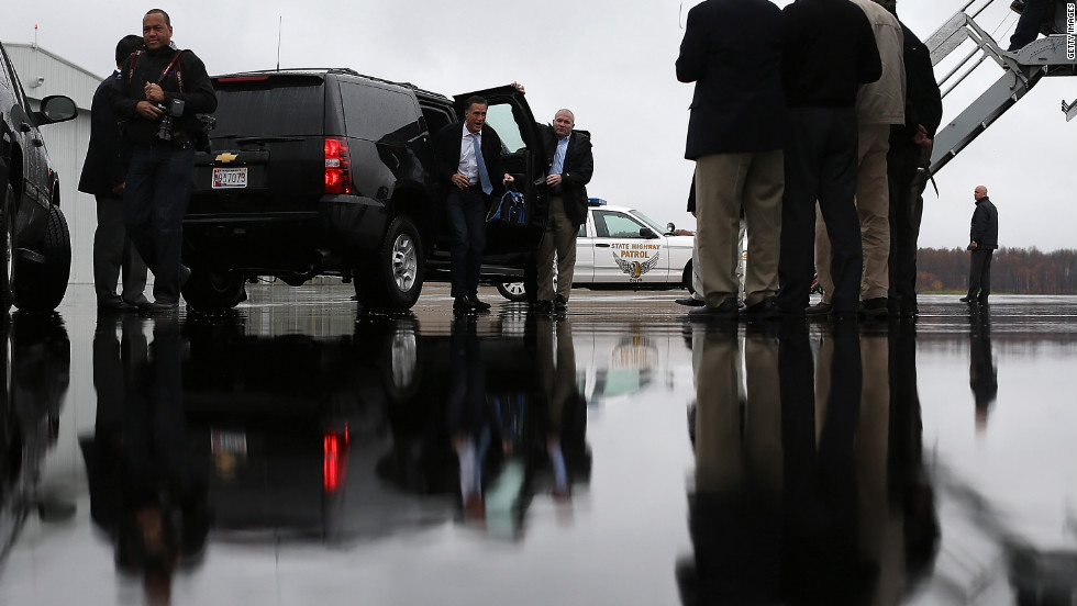 Romney emerges from his SUV at Akron-Canton Regional Airport on Saturday in Canton, Ohio.