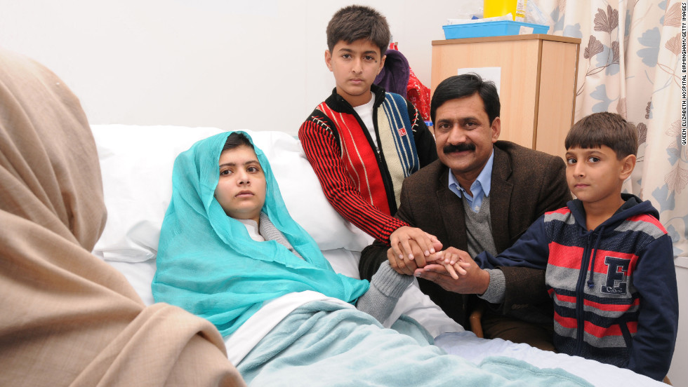 Malala sits up in her hospital bed with her father, Ziauddin, and her two younger brothers, Atal Khan, right, and Khushal Khan on Friday, October 26, 2012, at the Queen Elizabeth Hospital Birmingham in Birmingham, England.