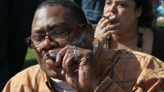 A  man joins other pro-marijuana activists in smoking pot at a rally in San Francisco to legalize the drug.