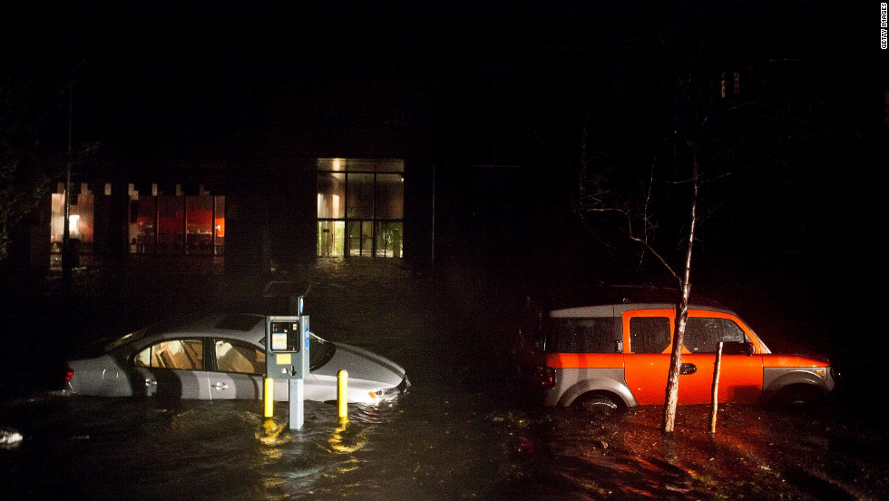 Flooded cars line the streets of New York&#39;s financial district Monday night.