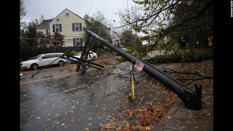 A power line knocked over by a falling tree blocks a street on Tuesday in Chevy Chase, Maryland.