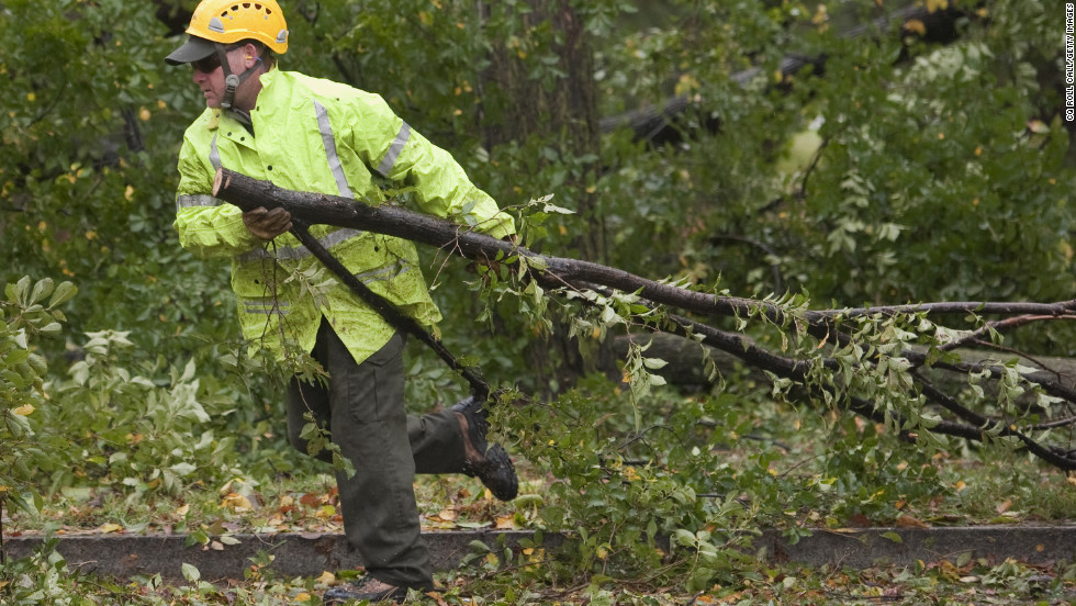 Downed trees are removed near the Korean War Veterans Memorial in Washington on Tuesday.
