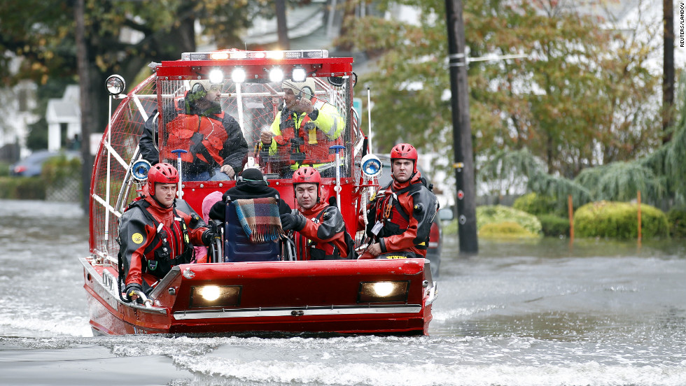 Rescue workers use a hovercraft to rescue a resident using a wheelchair from floodwaters in Little Ferry, New Jersey, on Tuesday.