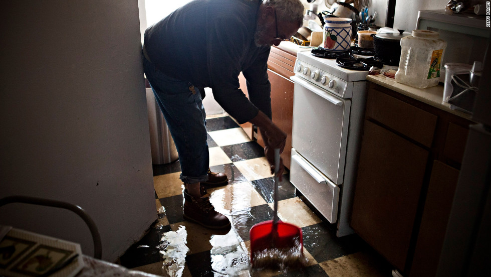 Jolito Ortiz helps clean up a friend&#39;s apartment on New York&#39;s lower east side on Tuesday.