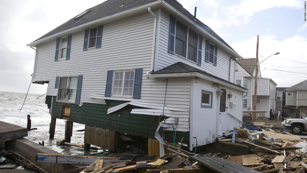 A home badly damaged by Superstorm Sandy sits along the shoreline in Milford, Connecticut, on Tuesday.