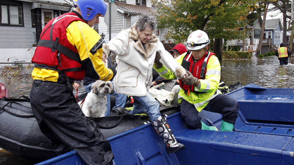Emergency personnel help a resident of Little Ferry, New Jersey, onto a boat after rescuing her from floodwater on Tuesday.