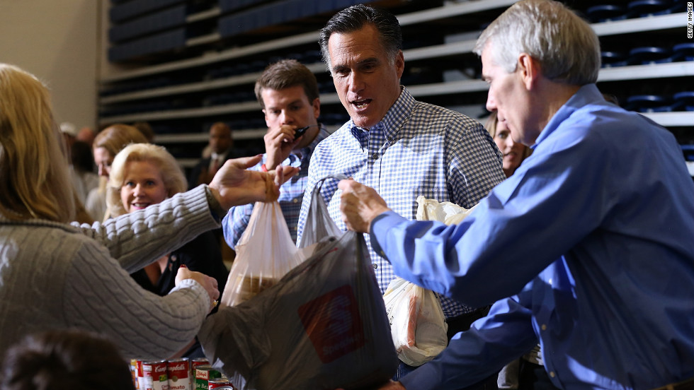 Republican presidential candidate Mitt Romney accepts a food donation for storm victims at an event in Kettering, Ohio, on Tuesday.