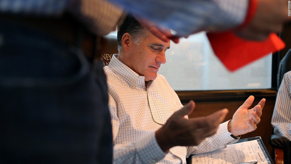 Romney talks with advisers on his campaign bus while en route to a rally at Avon Lake High School on Monday, October 29, in Avon Lake, Ohio.