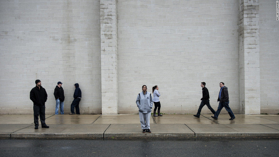 People wait outside a shelter at the Bergen County Technical Schools Teterboro Campus on Tuesday in Hasbrouck Heights, New Jersey. 