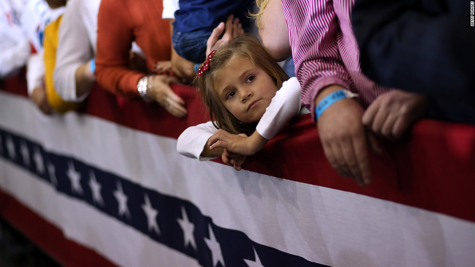  A young girl looks on during a campaign rally for Romney at Avon Lake High School on Monday.