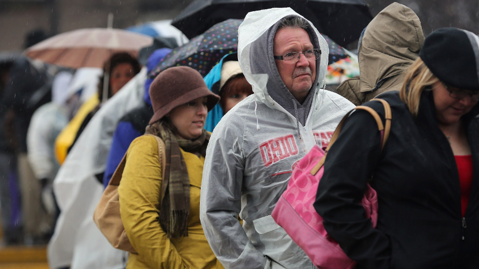 People line up in the rain for a campaign rally with Clinton and Biden on Monday in Youngstown, Ohio.