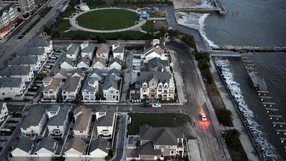 A police car patrols an empty waterfront neighborhood without power in Atlantic City, New Jersey, on Wednesday.