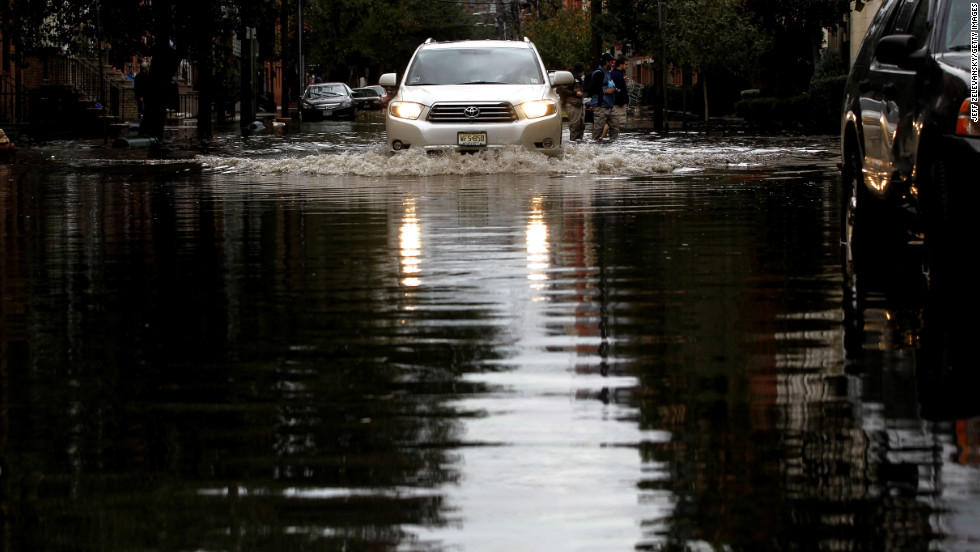 Motorists drive through standing water in Hoboken, New Jersey. Known as the Mile Square City, the low-lying neighborhoods suffered deep flooding resulting from the storm surge associated with Hurricane Sandy.