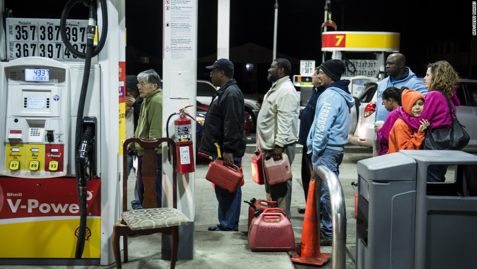 People wait in line to fill containers with gas at a Shell station in Edison, New Jersey, on Tuesday. Superstorm Sandy left much of Bergen County flooded and without power.
