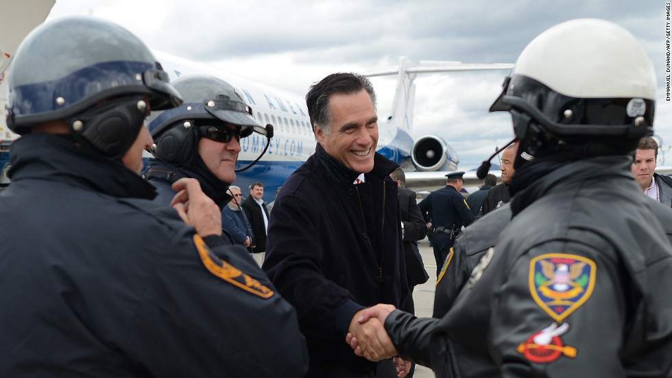 U.S. Republican Presidential candidate Mitt Romney greets policemen who were part of his motorcade as he prepares to board his campaign plane in Roanoke, Virginia on Thursday.