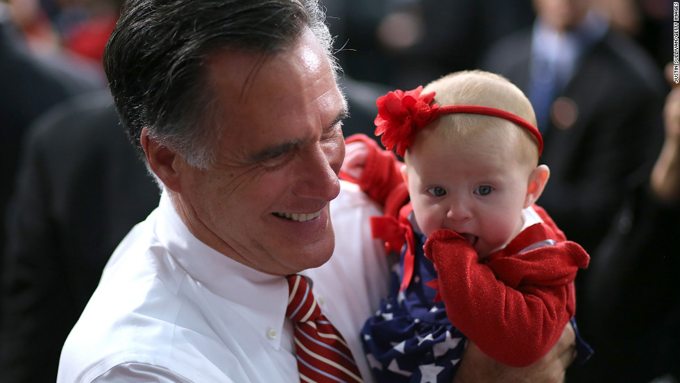 Mitt Romney holds a baby during a campaign event at Meadow Event Park on Thursday.