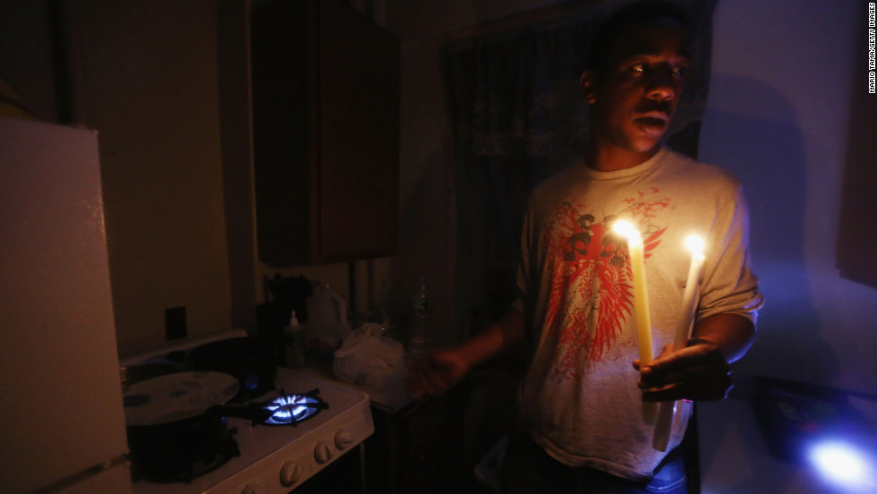 Geronimo Harrison&#39;s apartment in the East Village remains without power or water Thursday. He&#39;s using candles for light and a gas stove for heat.