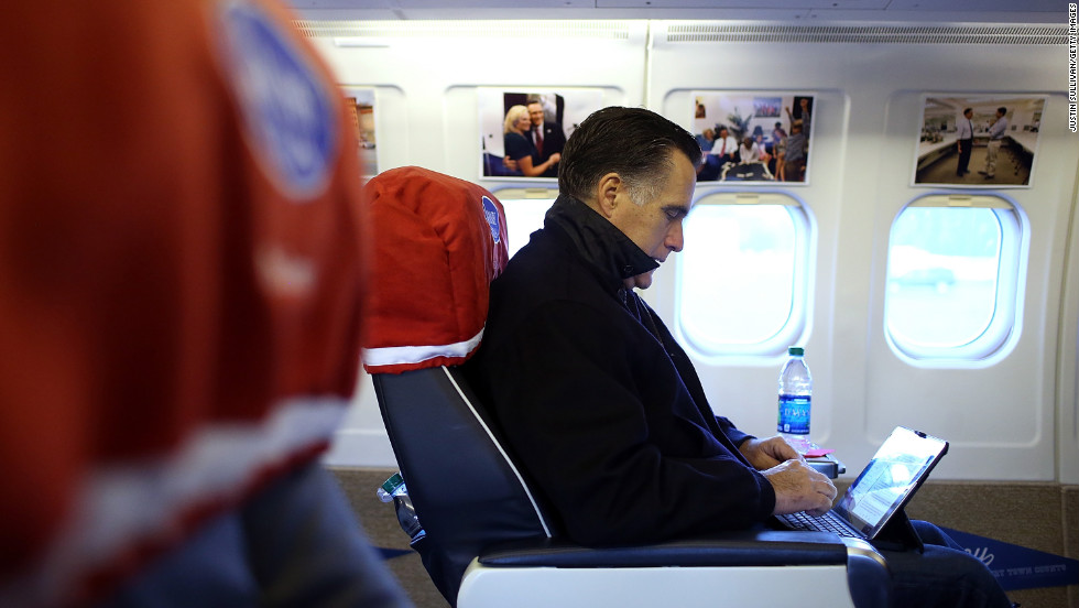 Republican presidential candidate Mitt Romney works aboard his campaign plane before takeoff Friday in Norfolk, Virginia.