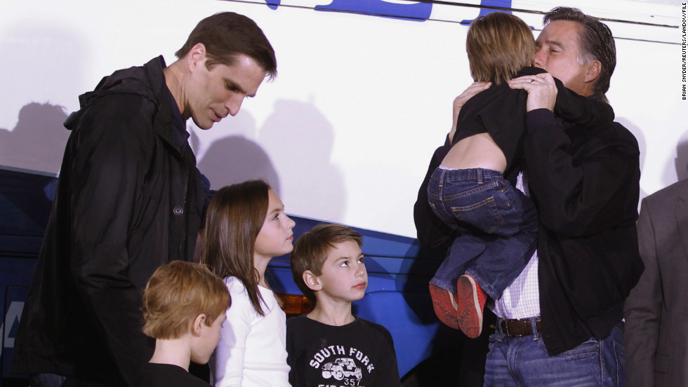 Mitt Romney gets a hug from his grandson Nash as, left to right, son Josh and grandchildren Owen, Grace and Wyatt look on at a campaign rally in 2012.