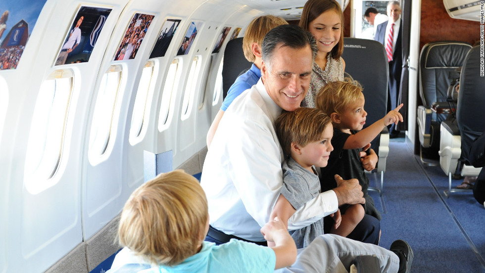 Mitt Romney plays with his son Josh&#39;s five children aboard his campaign plane in 2012.