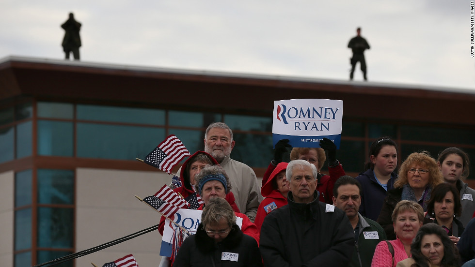 Supporters look on as Romney speaks during a campaign rally in Newington, New Hampshire, on Saturday.