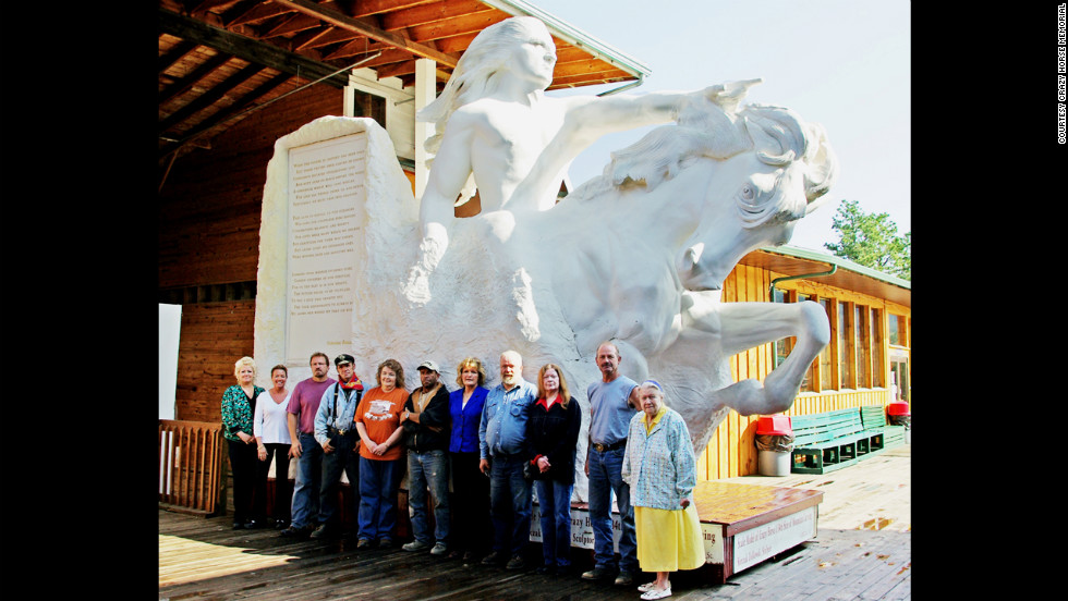 Ziolkowski&#39;s 10 children and his wife, Ruth, stand in front of a model of what the Crazy Horse mountain will look like when complete. 