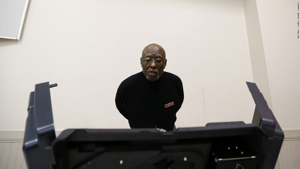 Precinct official Bill Partlow inspected a voting machine before polls open Tuesday in Pineville, North Carolina. 