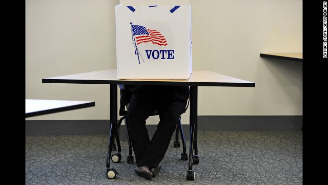 FAIRFAX, VA - NOVEMBER 06: A person casts their vote inside George Mason University on November 6, 2012, in Fairfax, Virginia. As Americans go to vote, U.S. President Barack Obama and Republican presidential candidate Mitt Romney are in a virtual tie in the national polls.  (Photo by Patrick Smith/Getty Images)