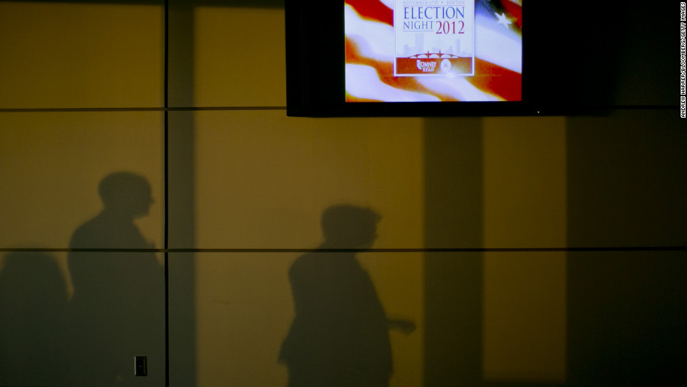 Shadows were cast on a wall next to a television advertising &quot;Election Night 2012&quot; inside the Boston Convention &amp;amp; Exhibition Center, where Republican presidential candidate Mitt Romney was scheduled to speak Tuesday evening.