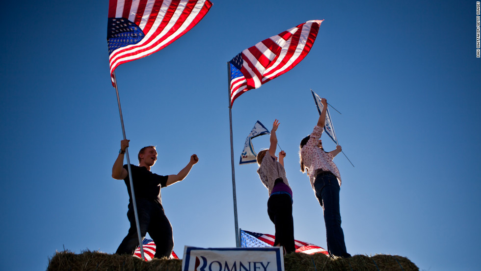 Justin Stucki, Leah Quirk, and Kenady Pettingill, left to right, urged drivers to vote for Republican presidential candidate Mitt Romney in Spanish Springs, Nevada. 