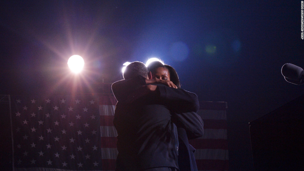 The president and first lady Michelle Obama embrace Monday in Des Moines at his last campaign rally before the election.