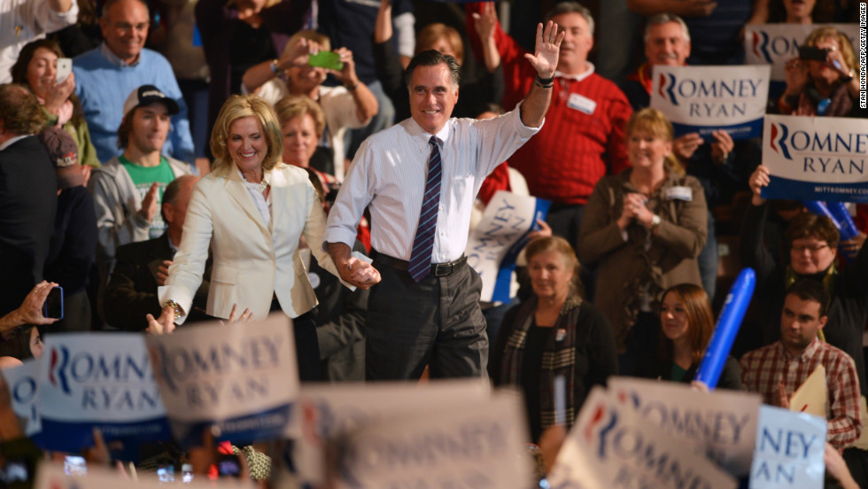 Romney and his wife, Ann, greet supporters at a rally late Monday in Manchester, New Hampshire. 