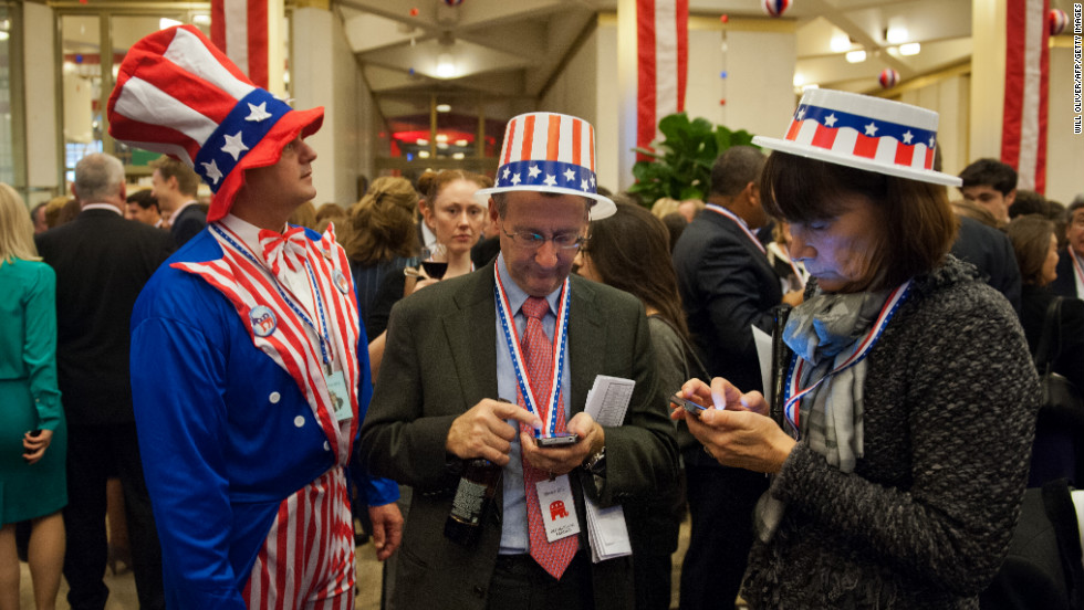 Party-goers wearing &#39;Stars and Stripes&#39; clothing awaited results at an election night party at the U.S. Embassy in London.