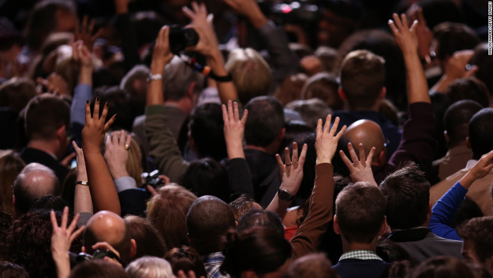 Obama supporters raised their hands in victory at an election night watch party in Chicago.  