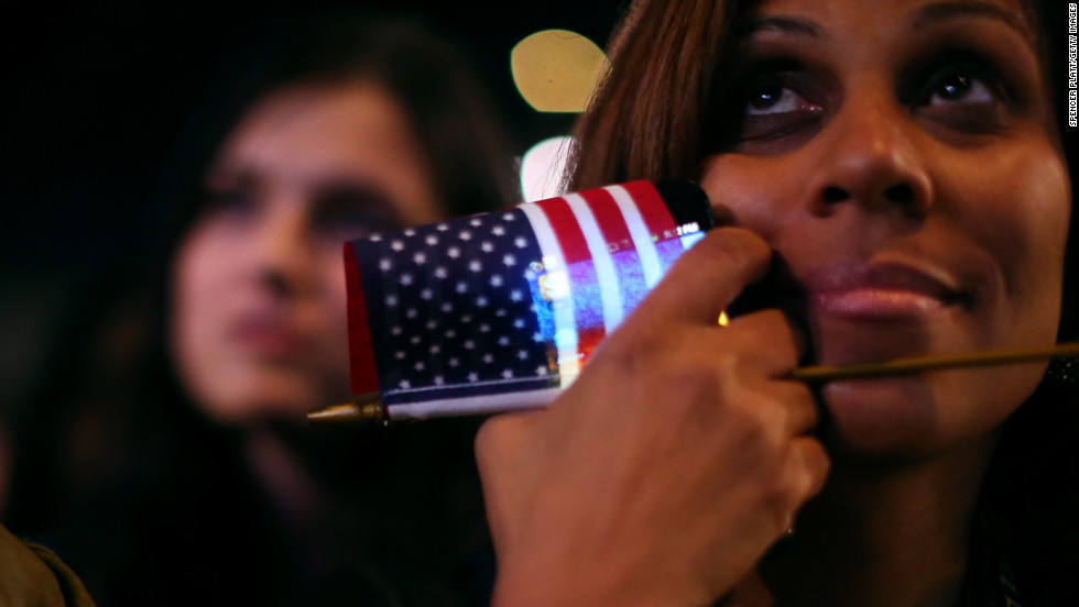 An Obama supporter clutched a flag and a smart phone at an election night rally in Chicago.