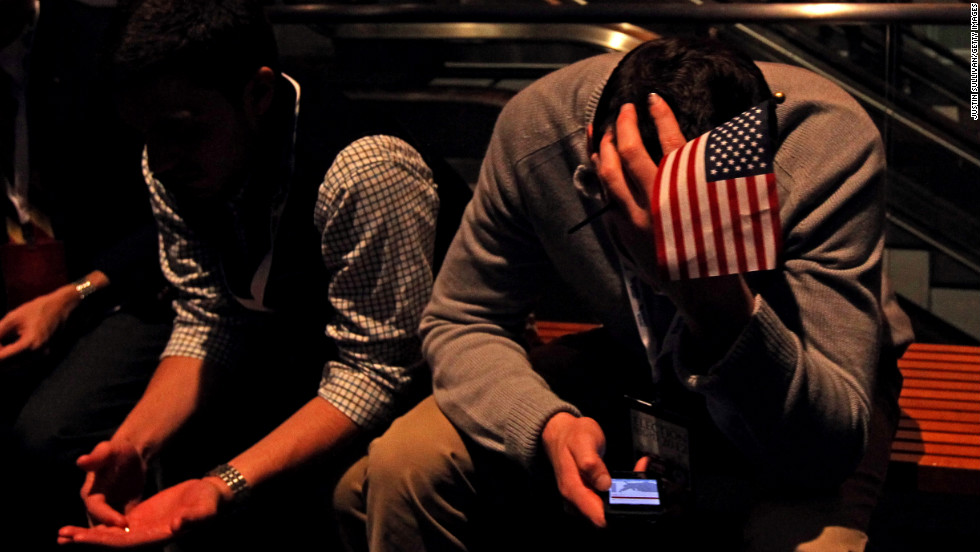 A supporter checks his smart phone while he waits for Republican Mitt Romney to give his concession speech in Boston, Massachusetts.