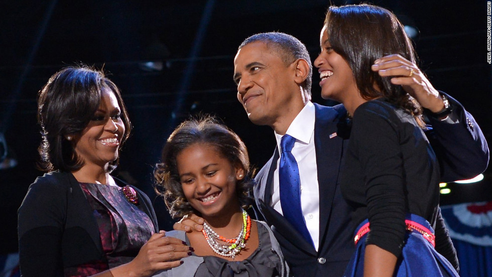 President Barack Obama embraced first lady Michelle Obama and daughters Sasha and Malia moments before he delivered a rousing victory speech.