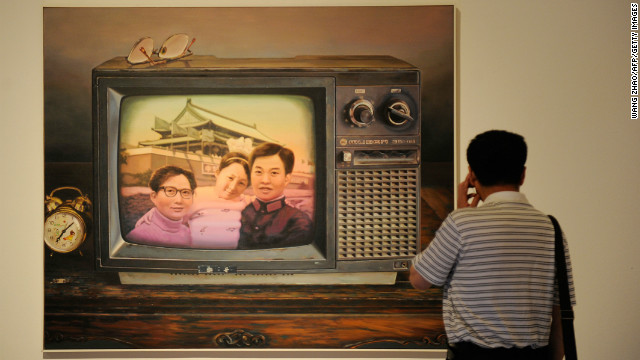 A man looks at a painting named &#39;Better To Have Only One Child&#39; at the China National Art Museum in Beijing in 2012. 