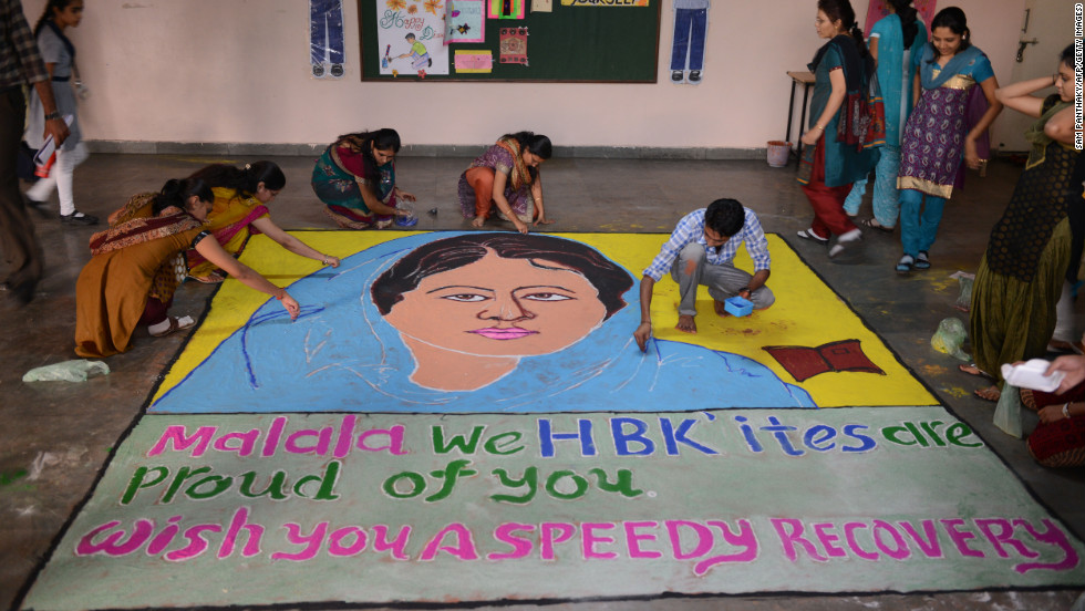 Indian teachers add finishing touches to a &quot;Malala Rangoli&quot; at a high school in Ahmedabad on Saturday.